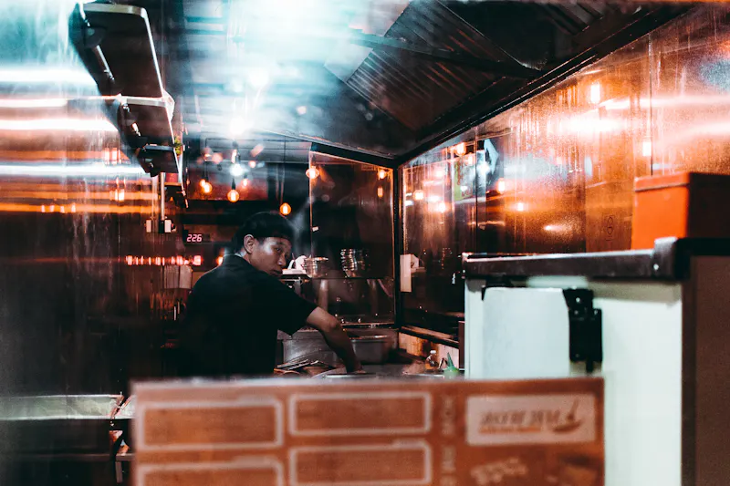 Chef preparing wings in kitchen